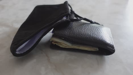 black mask and wallet on marble counter, no persons