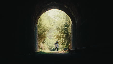 person walking through tunnel
