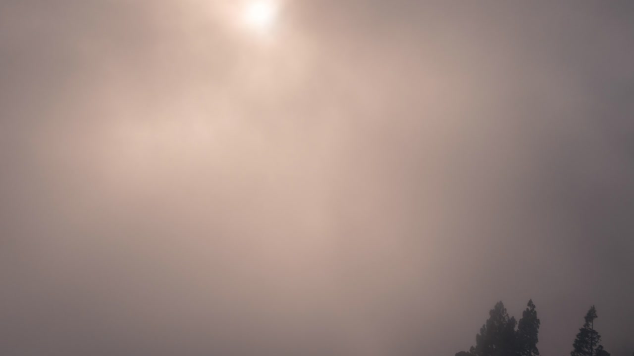 Dramatic timelapse of a cloudy valley in Gran Canaria at sunset. Warm golden light breaks through the mist, creating a breathtaking and cinematic scene. Perfect for nature, travel, and landscape