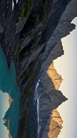 sunrise over alpine lake and mountain peaks