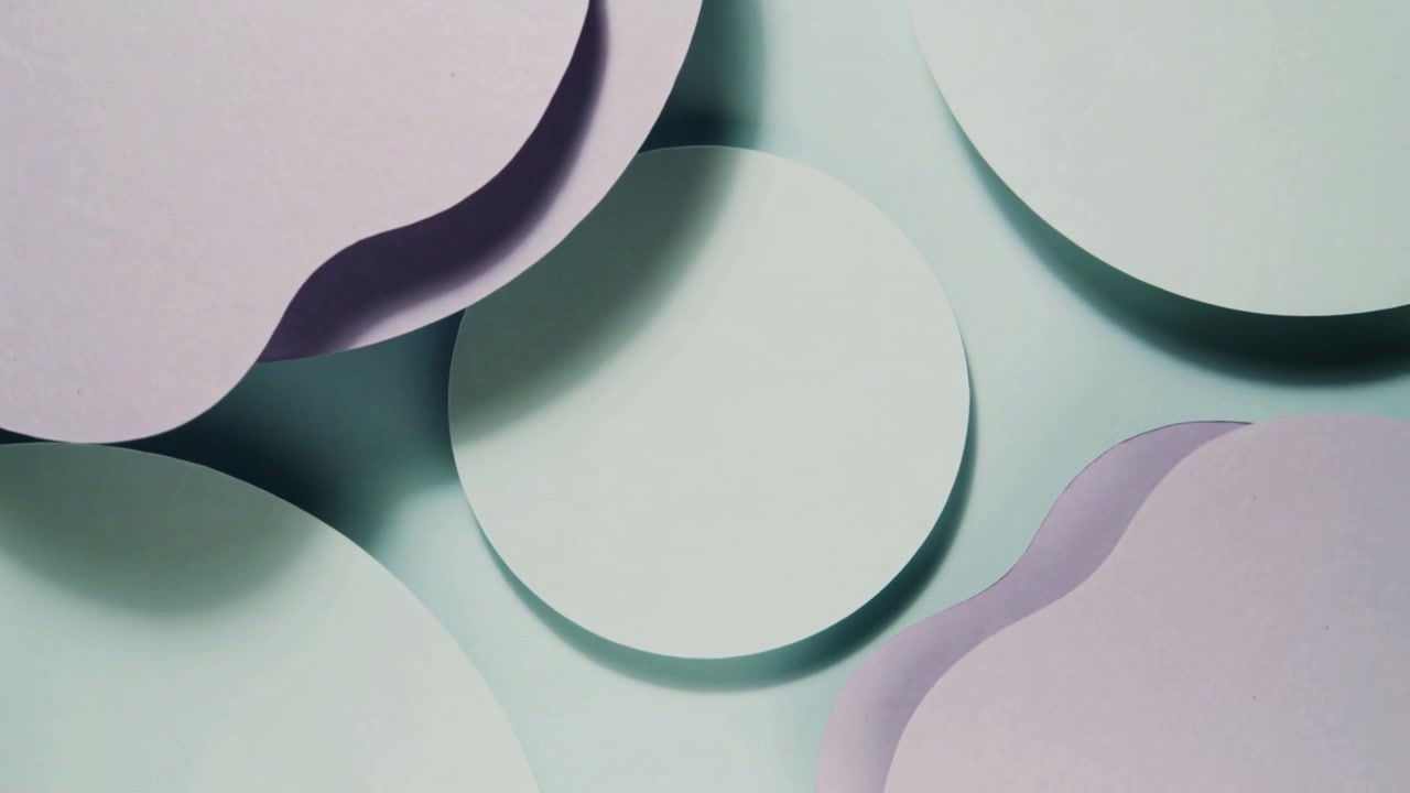 Animating top-left lavender scalloped piece shifting, revealing central mint-green disk on artboard