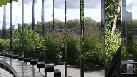 A-look-through-the-glass-within-Gasholder-Park,-Regents-Canal,-London,-United-Kingdom