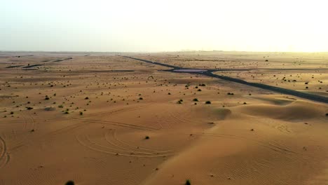 4k drone footage, a road between desert, dubai’s half desert road, geological landscape of high dune desert in the united arab emirates, drone videos