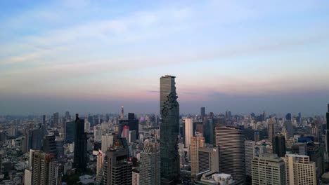 drone shot of mahanakhon tower in bangkok, silom area, business district, downtown