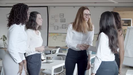 Group-of-multiethnic-businesswomen-shaking-hands