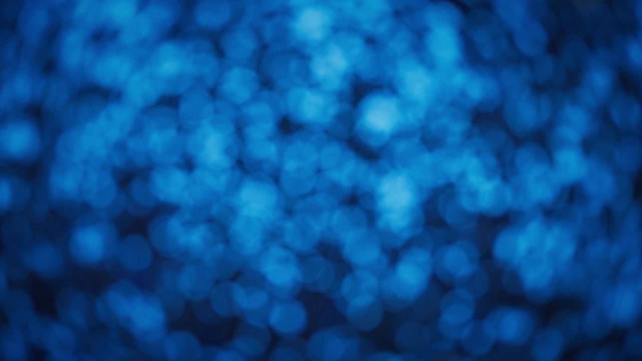 Glitter blu scintillante su sfondo bokeh astratto