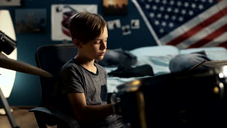 boy playing drums in bedroom