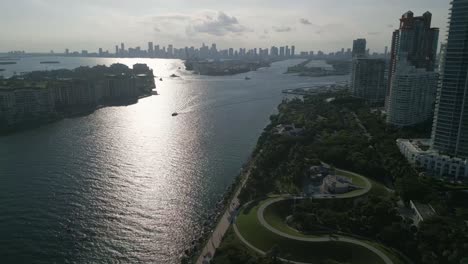 aerial of miami south beach skyline during a sunny day with parks and ferry boat