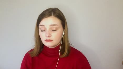 female young student visibly bored whilst looking directly into camera during remote lecture