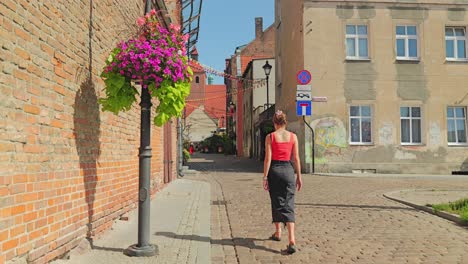 Charming old town atmosphere in Grudziadz with woman strolling cobbled streets