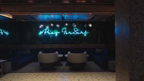 lounge area of five star hotel with flashing neon sign