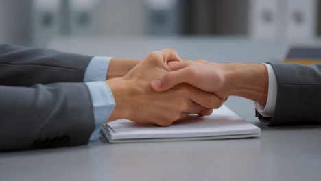 business handshake over a notebook