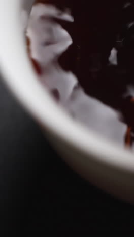 dark sauce in a white bowl