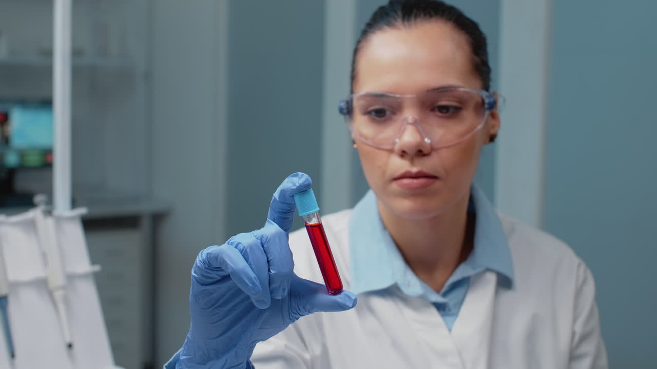 Scientist examining a blood sample in a lab