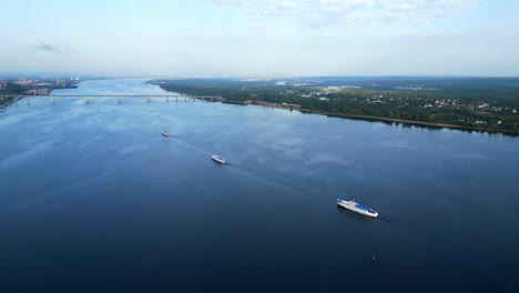 aerial view of ships and bridge on a wide river