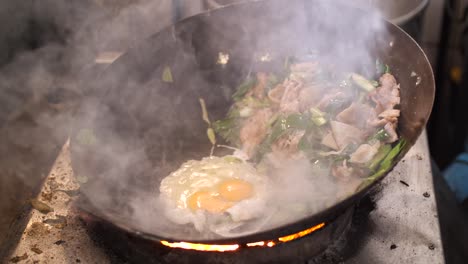 cooking delicious asian stir-fry in a wok