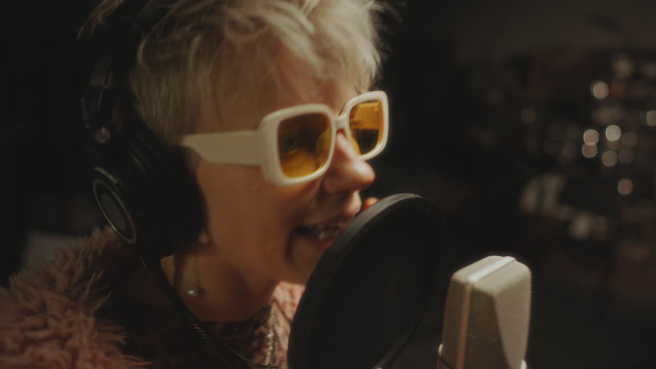 Expressive Female Musician Recording New Song in Professional Audio Studio