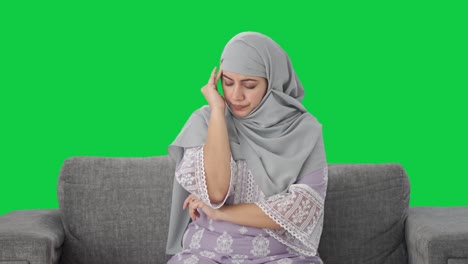 Sick-Muslim-woman-suffering-from-Headache-Green-screen