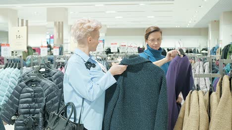 women shopping for coats in a clothing store