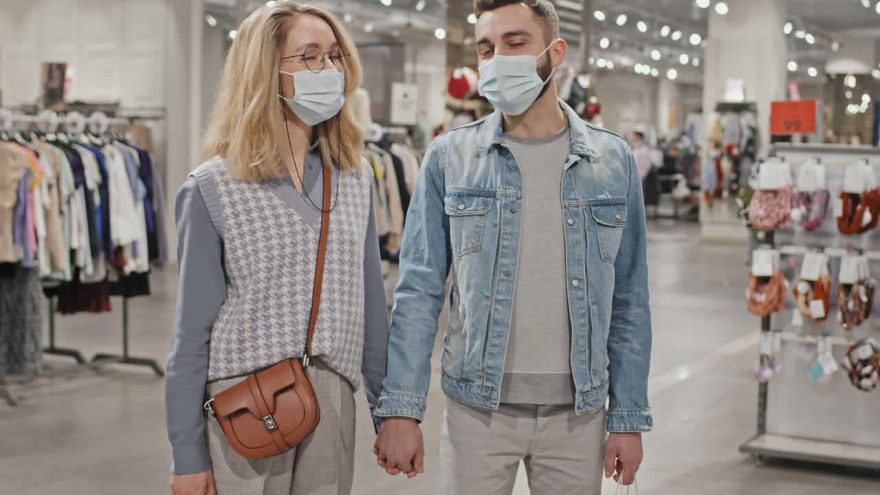 Portrait Of Stylish Couple In Face Masks in Clothing Store