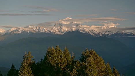 himalayas mountains landscape in nepal, beautiful dramatic scenery in amazing morning light at sunrise with forest of trees and himalaya mountain range with big snowcapped mountain tops and summit