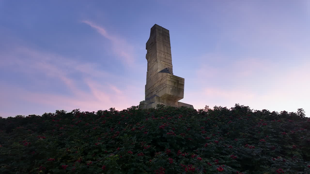 Majestic view of the Monument to the Defenders of the Coast at Westerplatte, Gdańsk, dramatically silhouetted against a beautiful pink and blue sunset sky