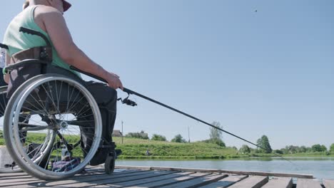 man with disabilities fishing at a lake. wheelchair. camping. summertime