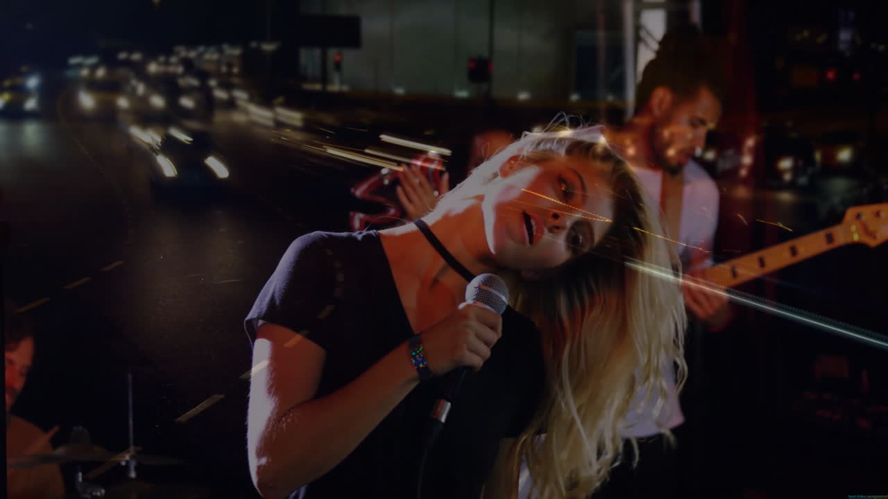 Lead singer leaning into microphone in music production scene, featuring animated car light trails