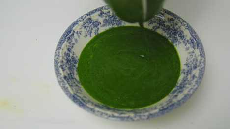 pouring spinach puree organic juice closeup