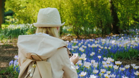 Tourist-Takes-Photo-Of-White-Tulips-And-Lilacs