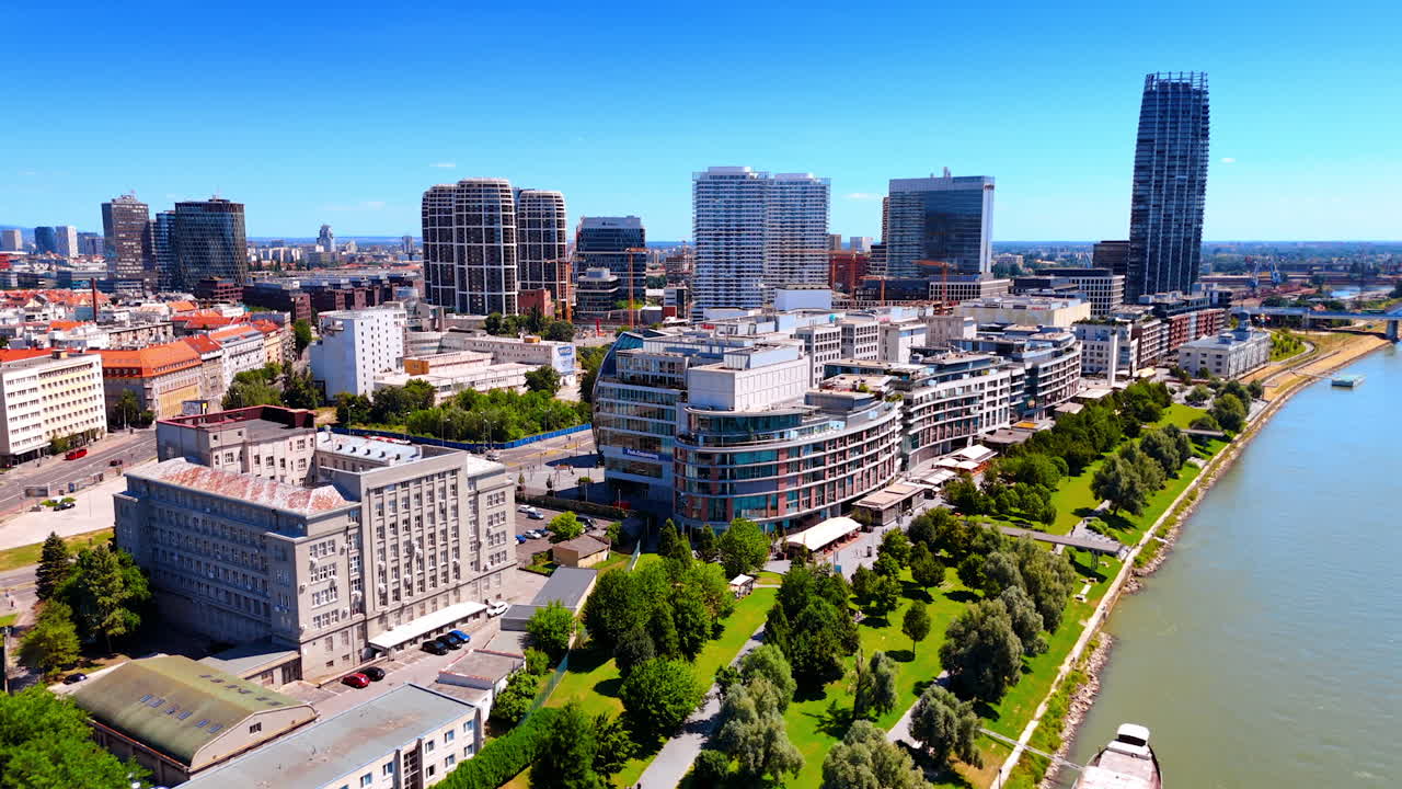 Bratislava's Danube skyline. Cityscape showcasing Bratislava's vibrant architecture, lush greenery, and the calm Danube river during a sunny day