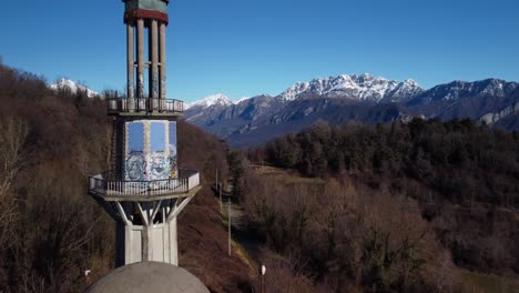 Close-up-aerial-of-Minaret-at-Consonno,-Italy,-drone-flying-forward,-day