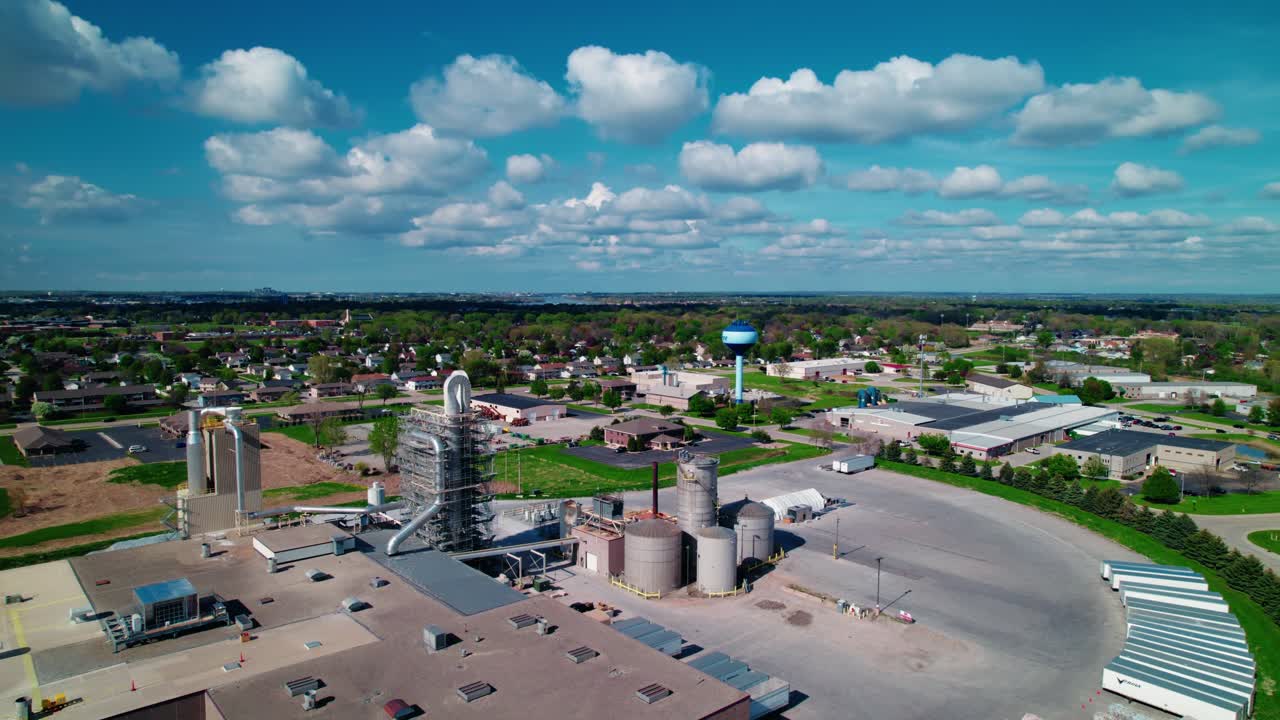 Smooth drone flight over a De Pere, Wisconsin industrial plant and silos—ideal for logistics, manufacturing, and environmental content.