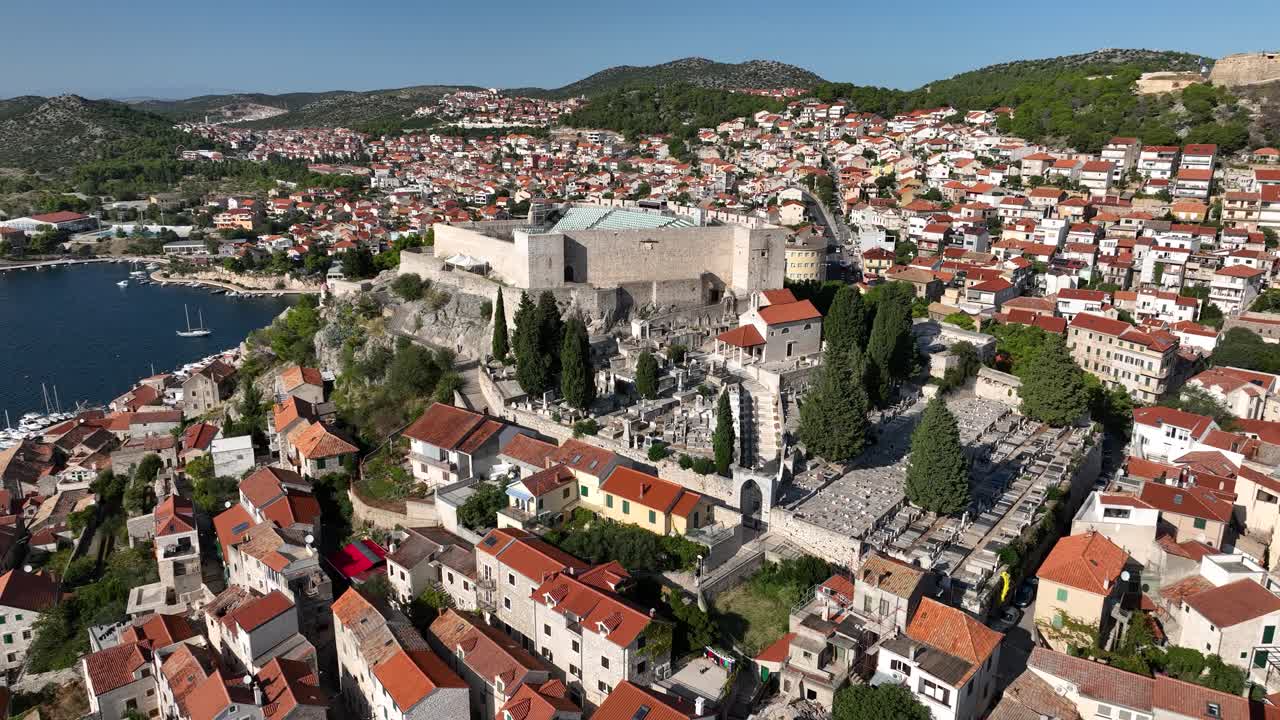 Sibenik with rooftops and historical landmarks overlooking the sea, aerial view