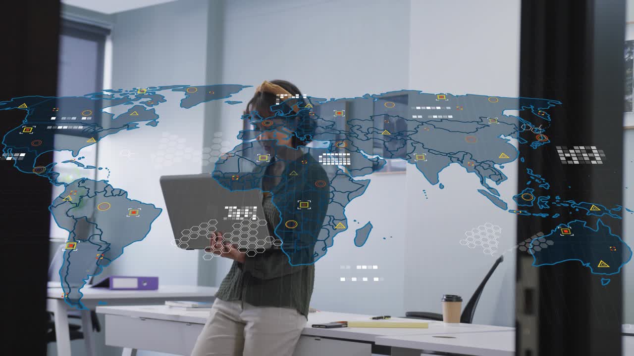 Woman leaning at desk tapping laptop, initiating technology map overlay with animated data nodes