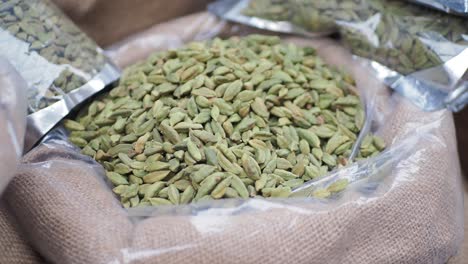 green cardamom pods in a burlap bag