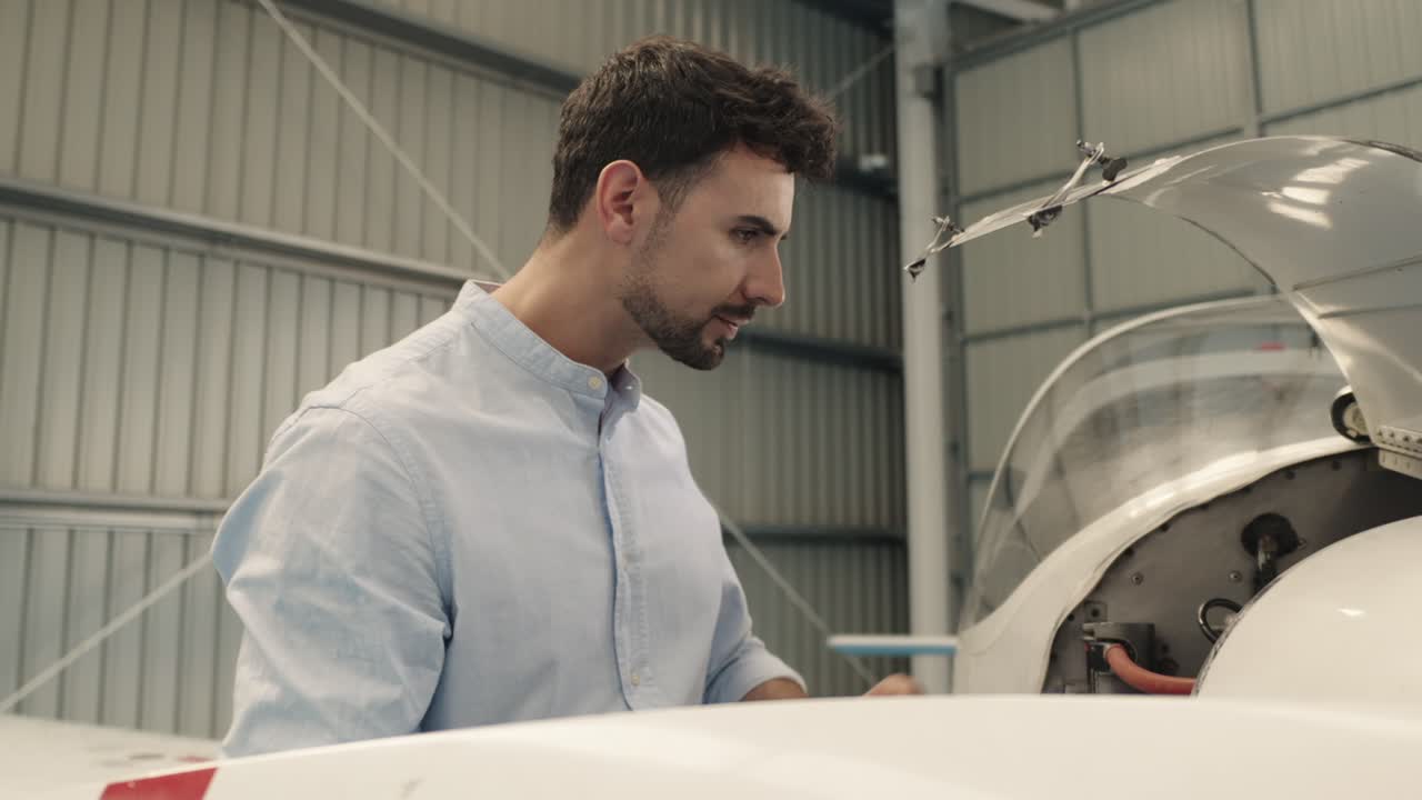 Man inspecting airplane in hangar