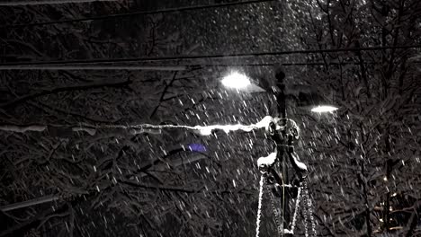 snowing in the city at night with light post, loop background