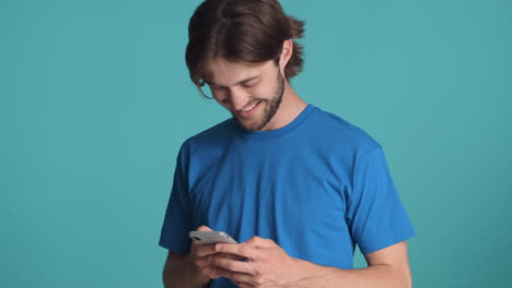 Caucasian-man-in-front-of-camera-on-blue-background.