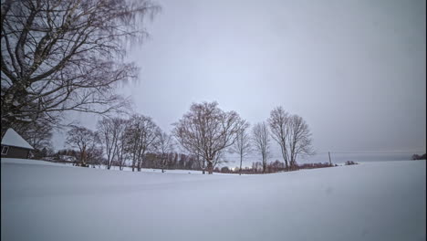 low angle timelapse of a winter scene in the countryside on a cloudy day