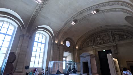 visitors admire art in louvre museum