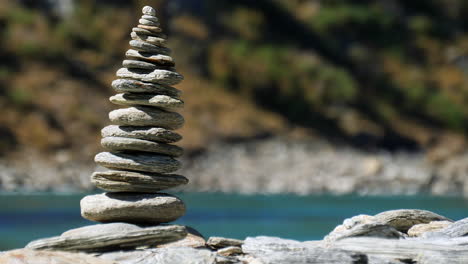 a stack of stones or cairn along the banks of the kawarau river in new zealand