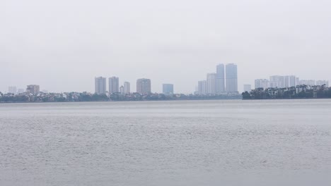 cityscape of hanoi with lake in foreground