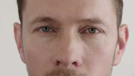 close up caucasian man face eyes opening looking at camera pensive contemplative on white background