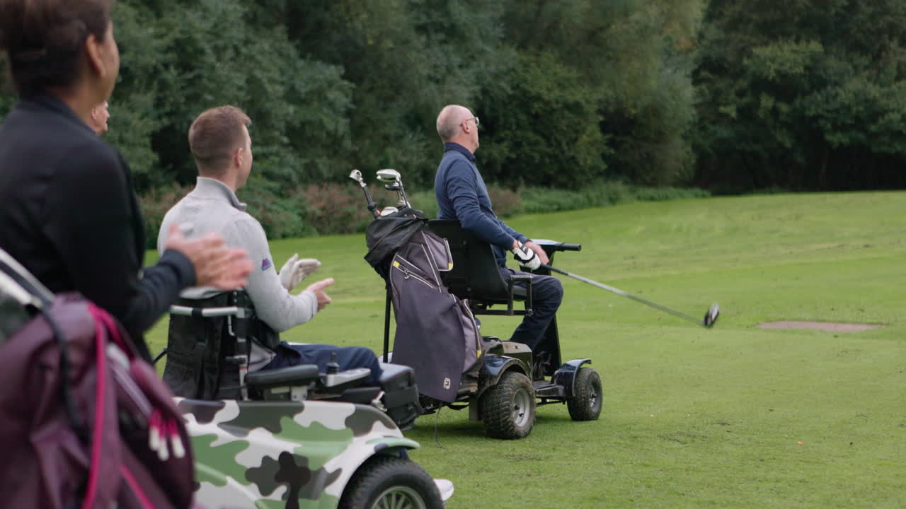 Golfers playing golf using mobility aids