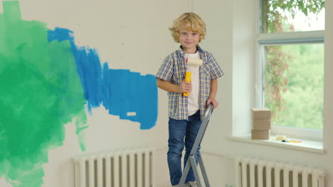 child painting a wall on a ladder