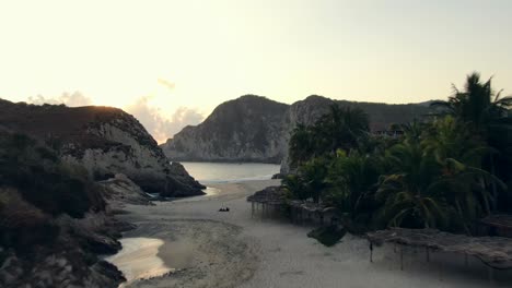 Drone-Flying-Over-Beautiful-Sandy-Beach-Of-Maruata-In-Michoacan,-Mexico-At-Dusk