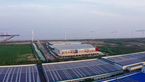 aerial shot of warehouse distribution center with windmills in the background