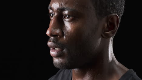 african american man in a close-up portrait on a black background