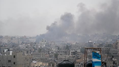 smoke billowing from the remains of gaza after months of prolonged conflict